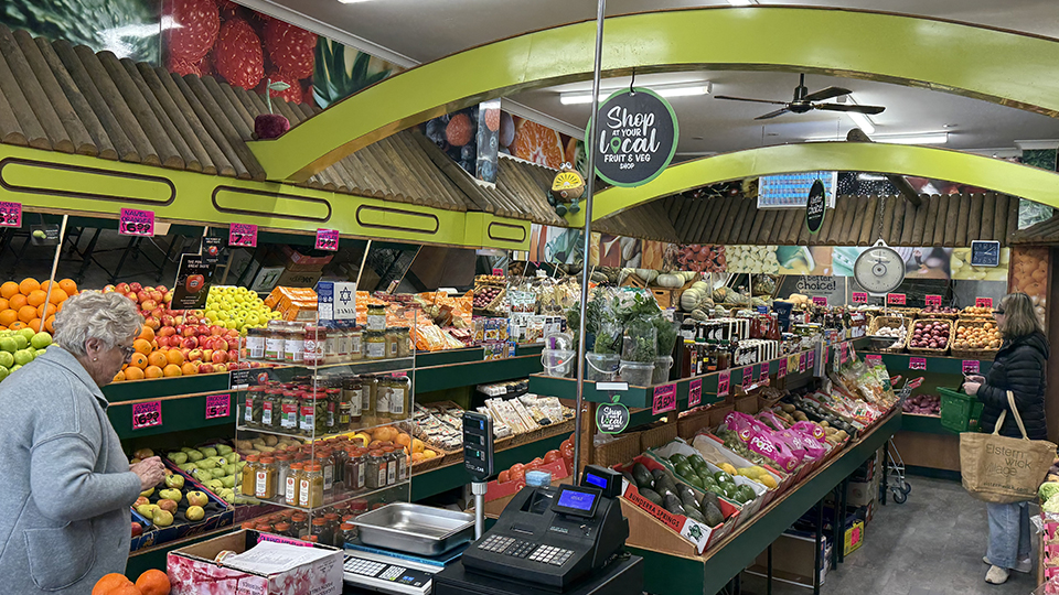 Colourful fresh fruit and vegetable displays inside an Elsternwick greengrocer called Dirito's Quality Fruits.