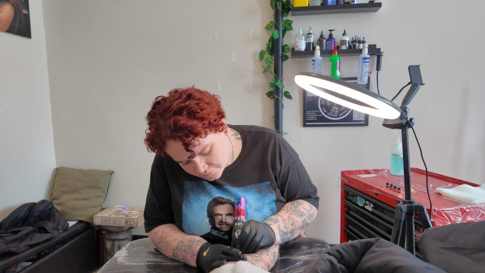 Sacred Ink Collective tattoo artist at work