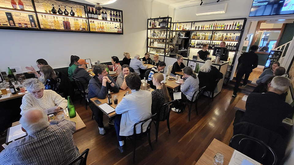 A busy evening inside Budapest restaurant, with diners gathered around tables in the Elsternwick dining room.