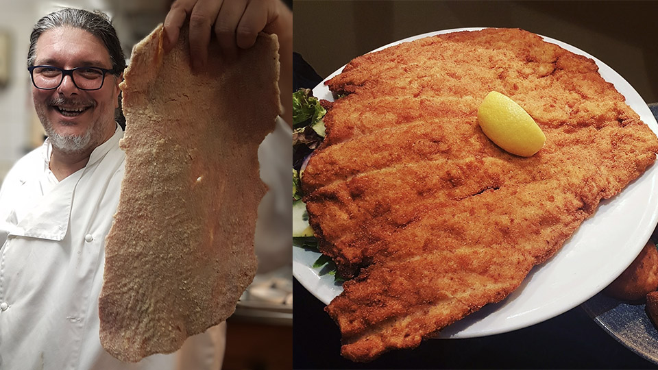 Head chef Viktor holding an uncooked giant schnitzel alongside the finished crumbed schnitzel served with a lemon wedge.